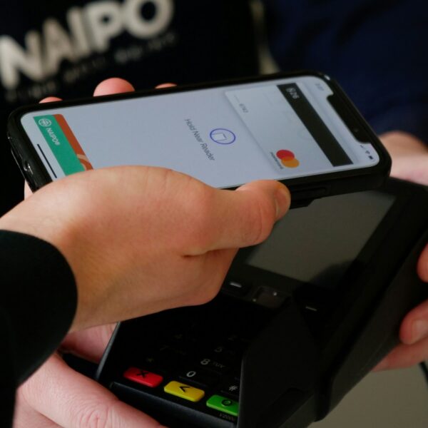 a person paying with a phone at a pos system
